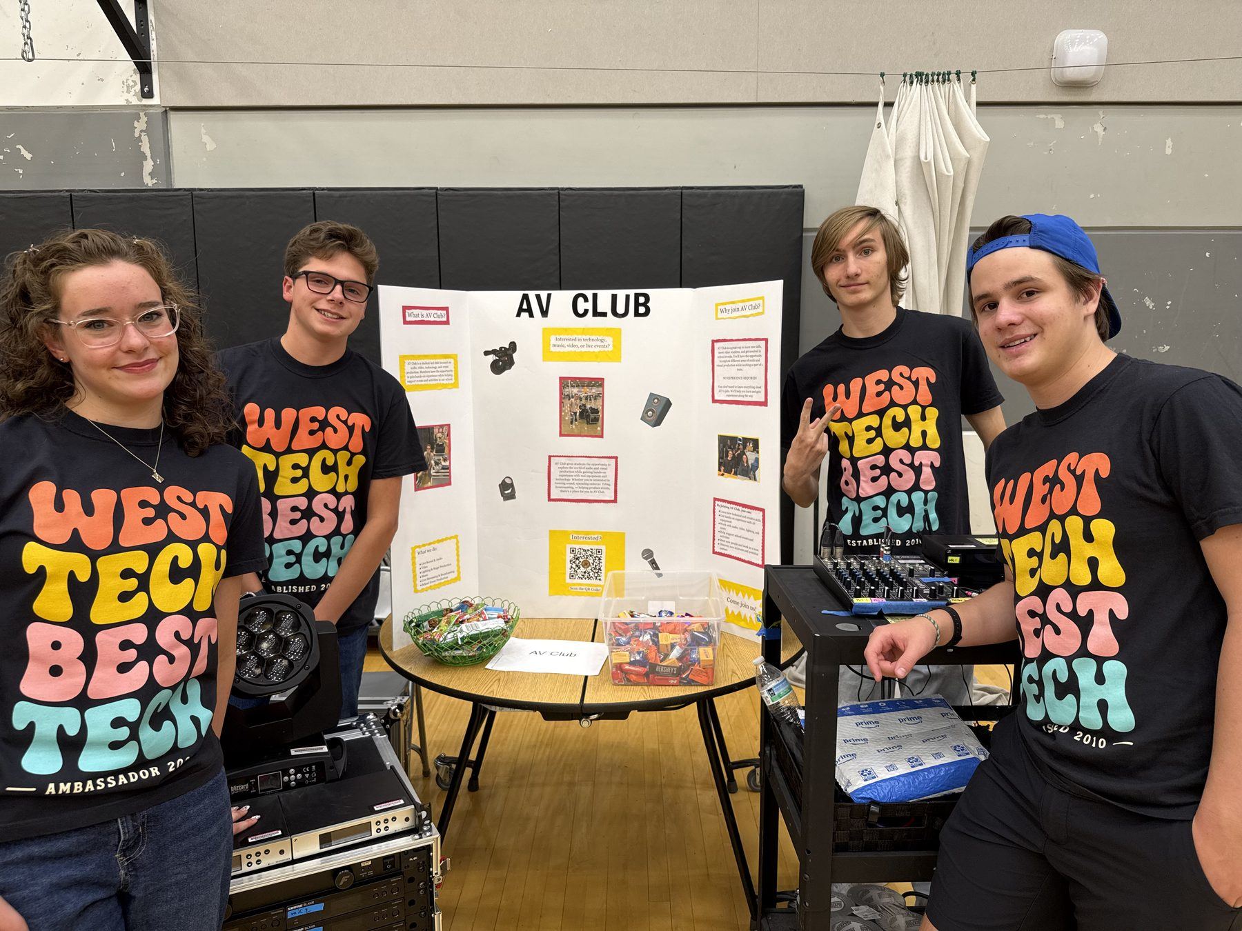 AV Club members behind their table at club sign up night, with gear set up in front